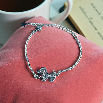Playful Silver Dog Charm Bracelet with Ruby Accent